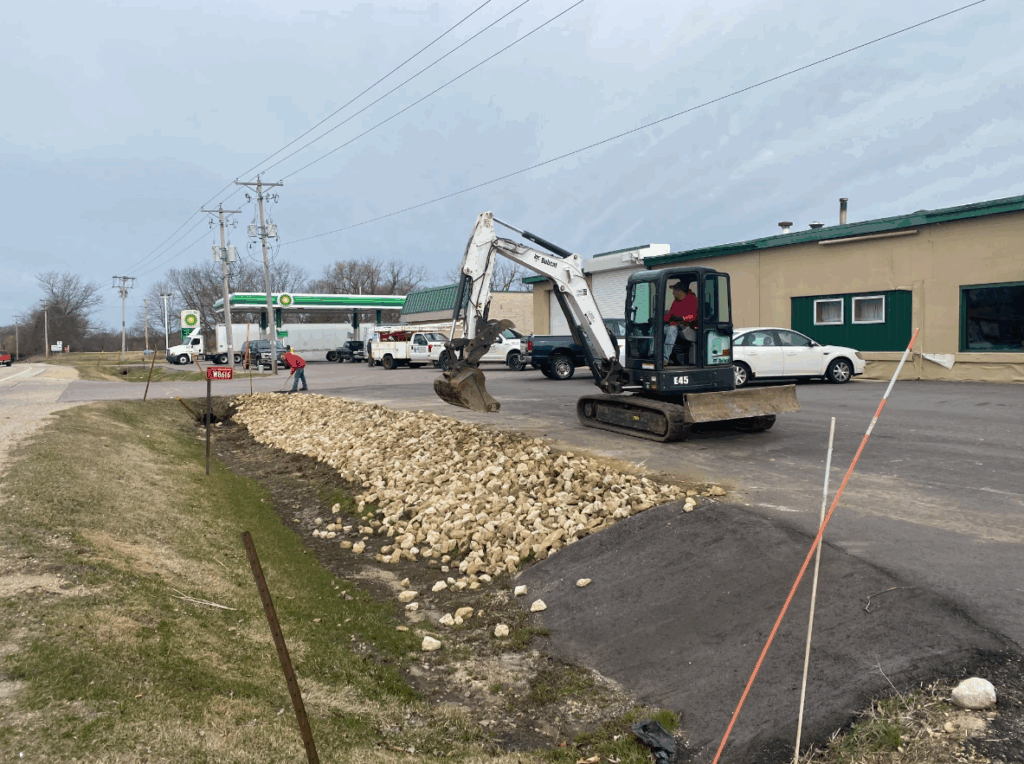 spreading rocks in a new ditch